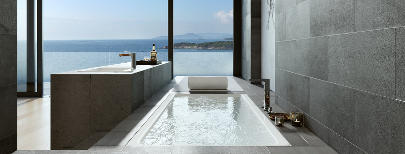 Beautifully designed bathoom with a bath full of water overlooking the ocean